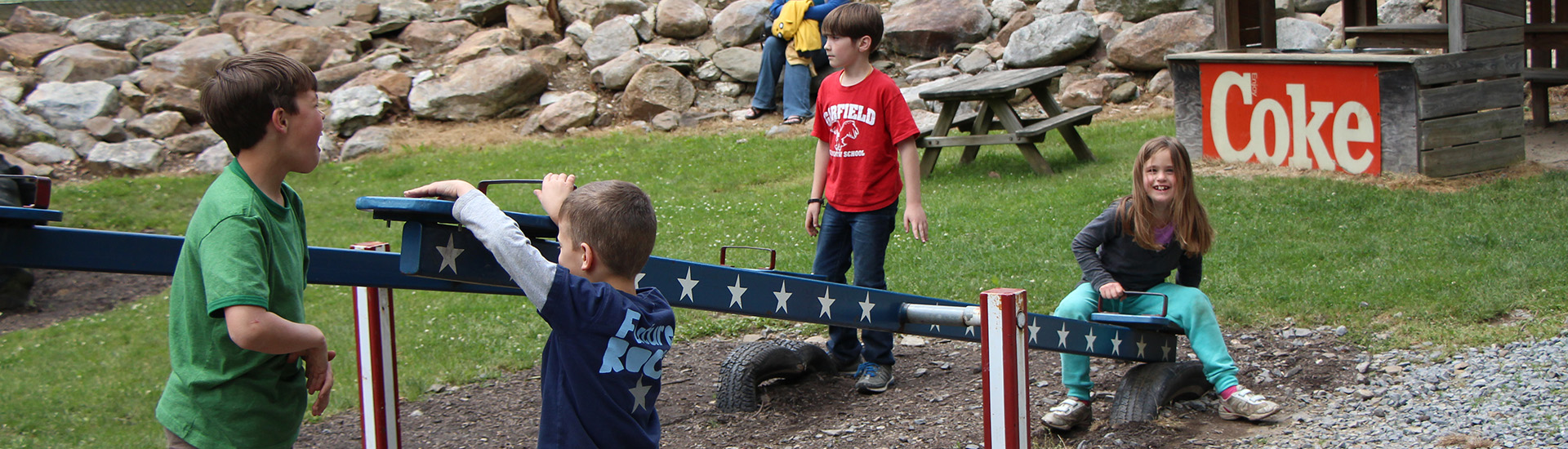 Kids playing on a teeter-totter.